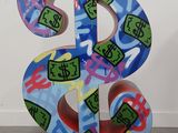 a colorful painted dollar sign on display in a room