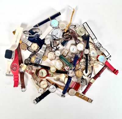 une pile de montres de toutes sortes posées sur une table