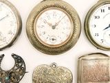 many different types of pocket watches displayed on a white surface