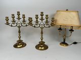 brass candlesticks with a lamp and a lamp shade on a white background