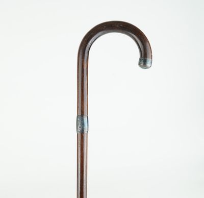 a close up of an umbrella with a wooden handle on a white background