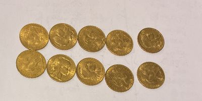 a bunch of gold coins sitting on top of a white surface