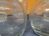 two glass vases that are sitting on a table