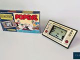 a small electronic game in front of a box