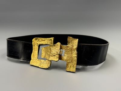 a close up of a black belt with a gold buckle
