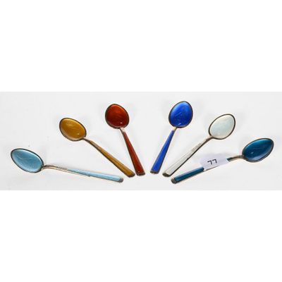 several spoons are arranged in a circle on a white surface