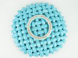 turquoise beaded broochle with a ring on top of it