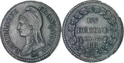 a silver coin with a woman ' s head and a wreath on it