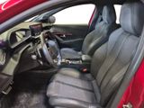 the interior of a red car with black leather seats and a steering wheel