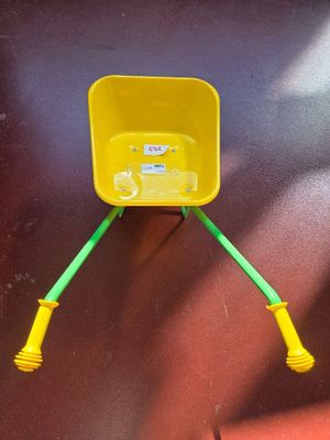 a yellow bucket with a green handle attached to it