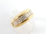 an image of a gold ring with baguets of diamonds