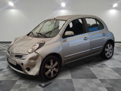 a silver car that is sitting on a checkered floor