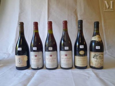 several bottles of wine are lined up on a table