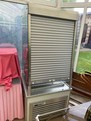a refrigerator that is sitting in the corner of a room