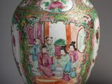 a vase that has a painting on it on the table