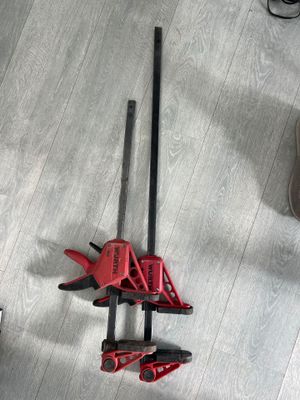 two tools that are laying on the floor next to each other