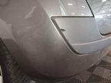 the front bumper of a car with a denting dent on it