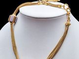 a close up of a necklace on a mannequin mannequin