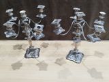 two silver metal candlesticks are sitting on a wooden table
