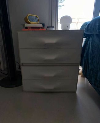 a picture of a bedroom with a bed and a nightstand