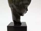 an image of a bronze sculpture of a woman ' s head on a black stand
