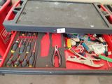 many tools in a tool box on the floor