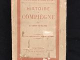 an old book on a black background with a red border