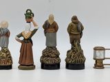 five figurines of people that are standing in a row