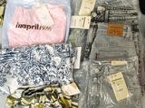 a lot of clothes that are sitting on a table