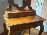 a wooden vanity with a mirror on top of it