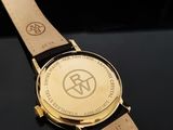 an image of a close up of a watch on a black surface