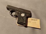 Gros plan sur un pistolet posé sur une table et auquel est attachée une note.