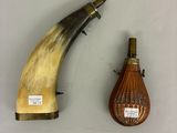 two pieces of horn and a bottle of wine on a table