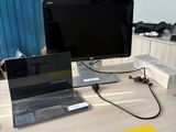 a desk with a laptop and a monitor on it