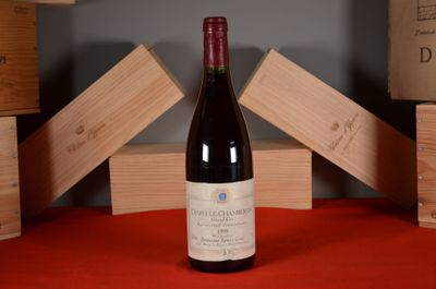 a bottle of wine sitting on a red table cloth