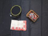 une boîte de fils et une boîte de fils posées sur un tissu noir