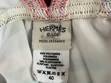 the label on the back of a white dress with pink trims