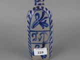 an old blue and white vase sitting on top of a table