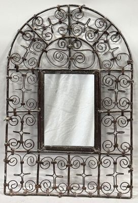 wrought iron wall mirror with ornate design and glass frame