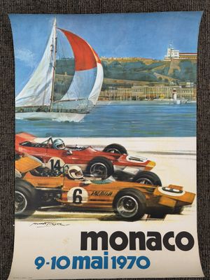 a poster of a race car and a sailboat on the beach