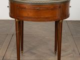 a round table with a marble top on a wooden floor