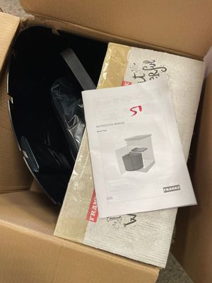 a cardboard box with a helmet and other items in it