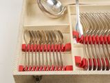 a box with a bunch of forks and spoons in it