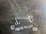 a close up of a metal object with a name on it