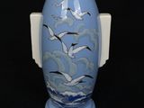 a blue vase with seagulls painted on it