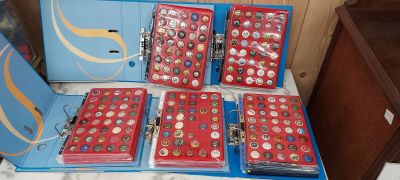several boxes of buttons are sitting on a table in a room