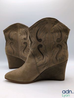 a close up of a pair of cowboy boots on a white background
