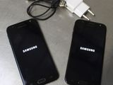 two cell phones sitting next to each other on a table