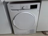 a white washer and dryer in a small kitchen