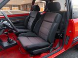a red car with black seats and a steering wheel